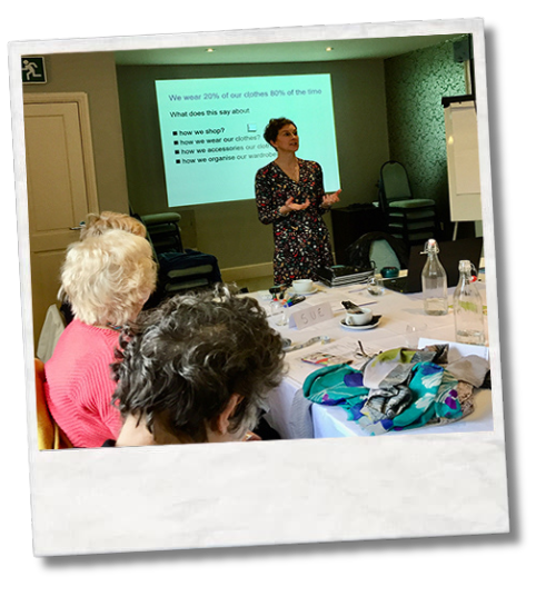 Person speaking to a group during a style workshop indoors